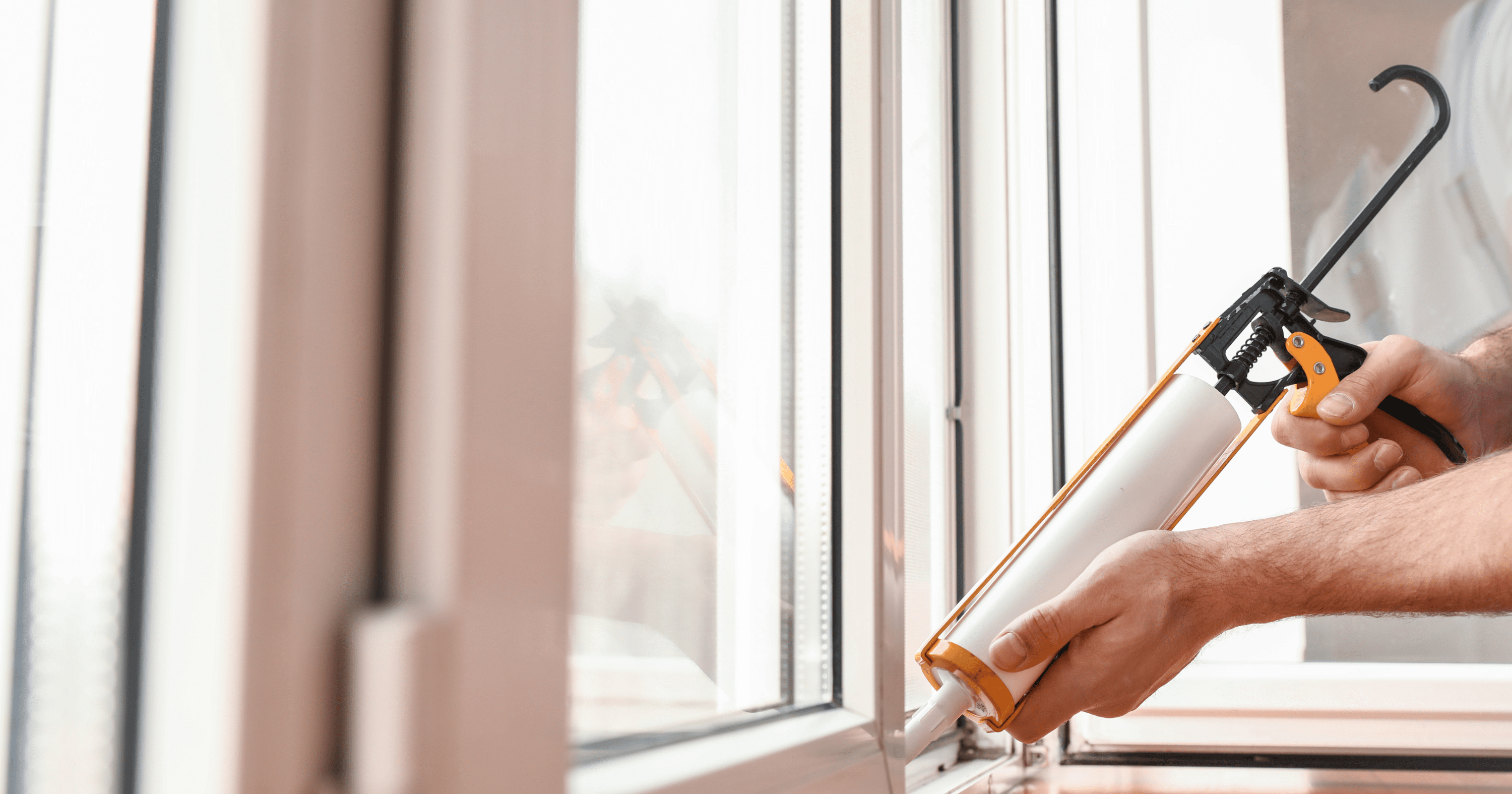 A stock image of a person sealing a window - start your property search on Share to Buy!