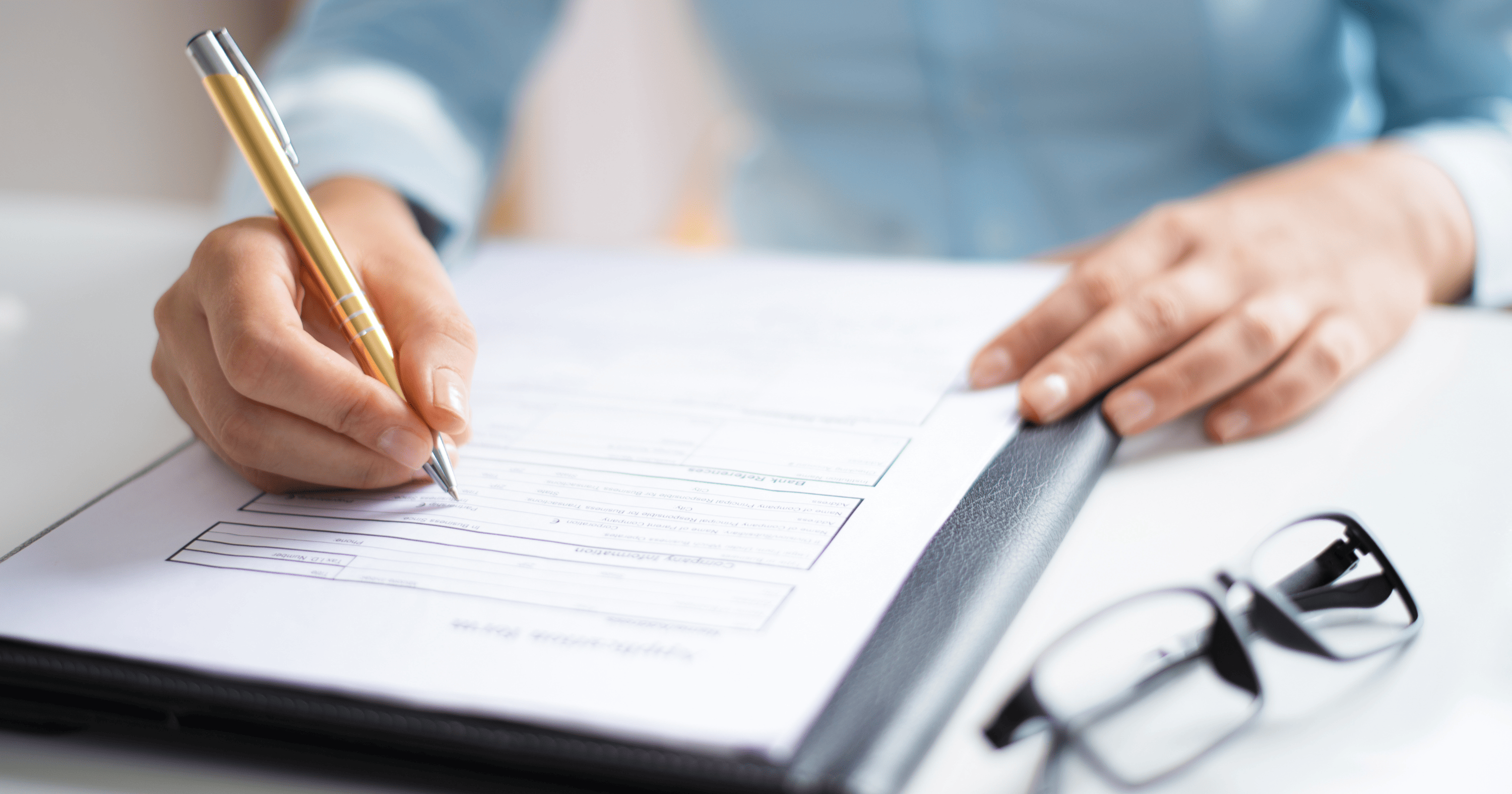 A stock image of a person inspecting documents.