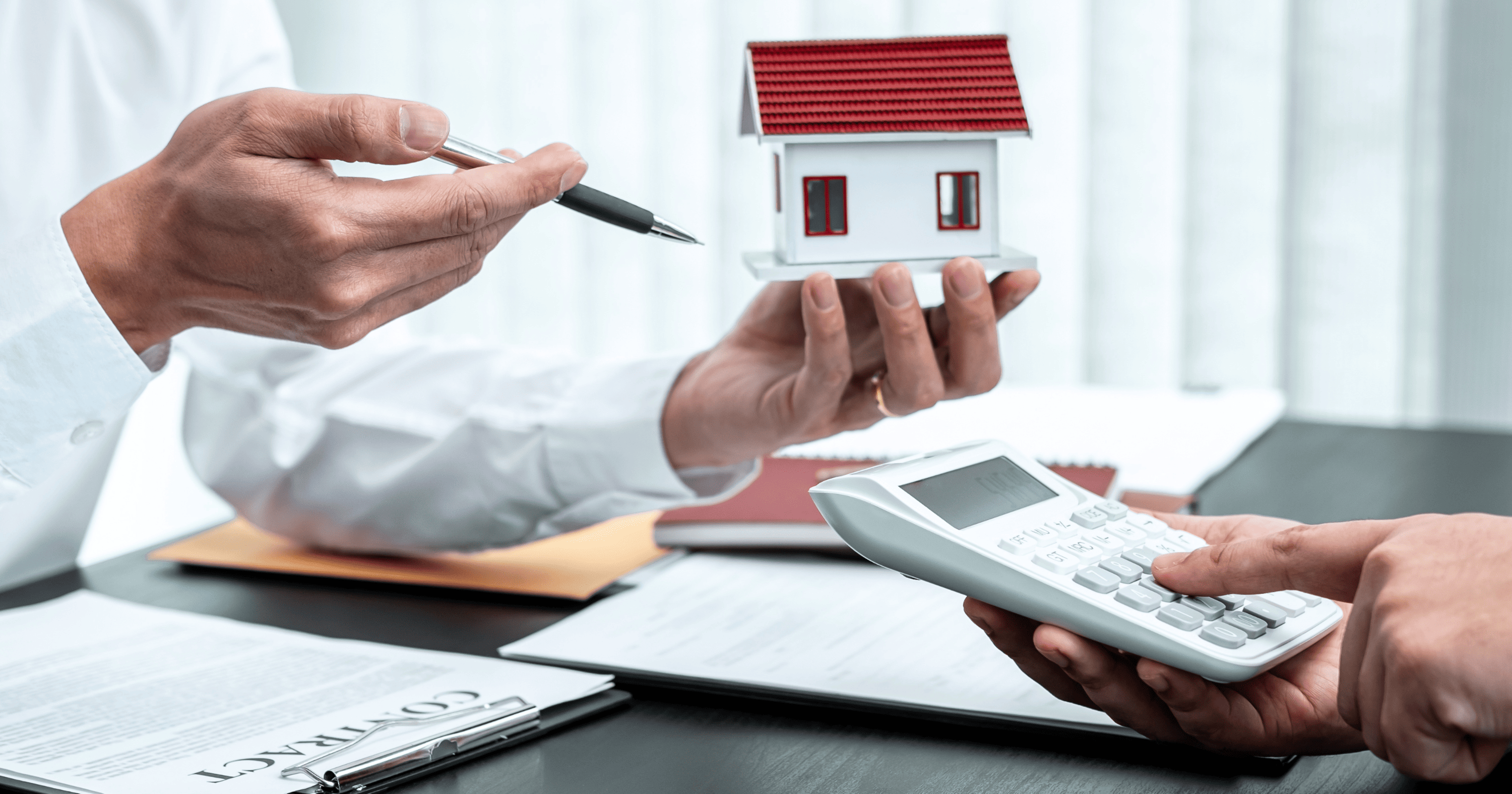A stock image of a model house and a calculator. Find a Shared Ownership mortgage with Censeo Financial - Share to Buy's broker partner!