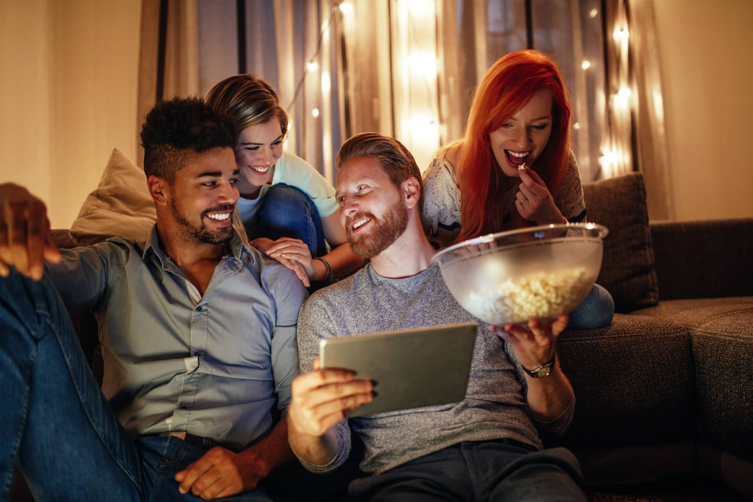 Stock image of friends watching a movie - Start your property journey on Share to Buy!