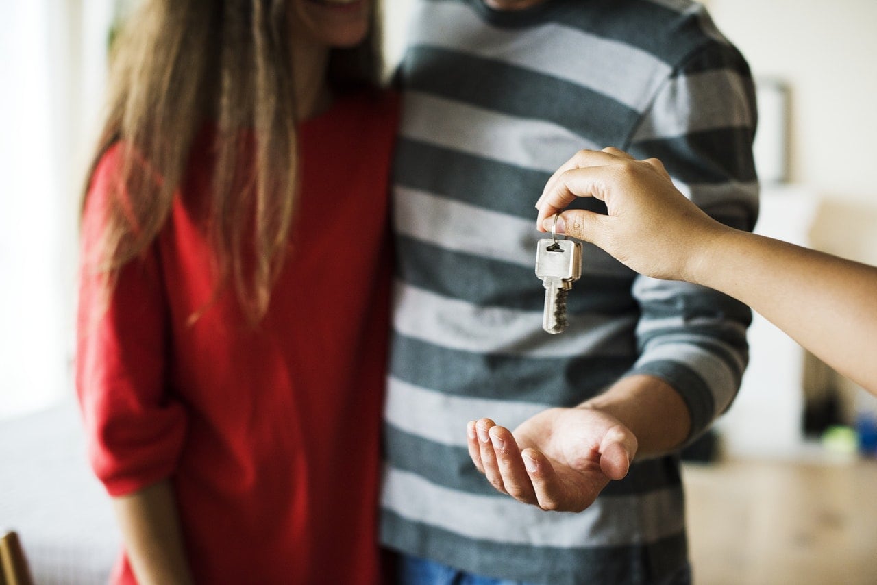Stock image of people getting keys - Start your property journey on Share to Buy!