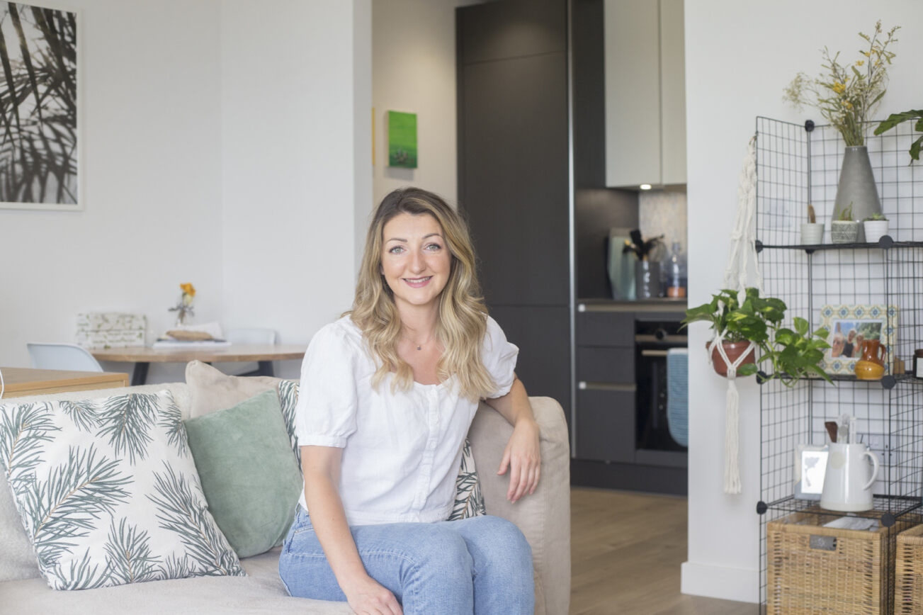 Stock image of a women on a sofa - Start your property journey on Share to Buy!