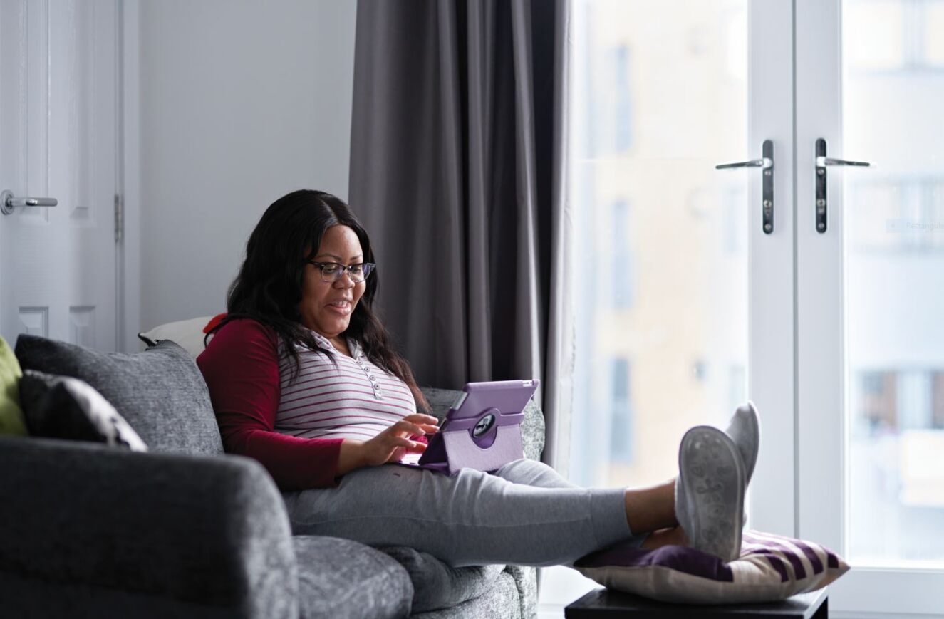 Stock image of a women on her tablet - Start your property journey on Share to Buy!