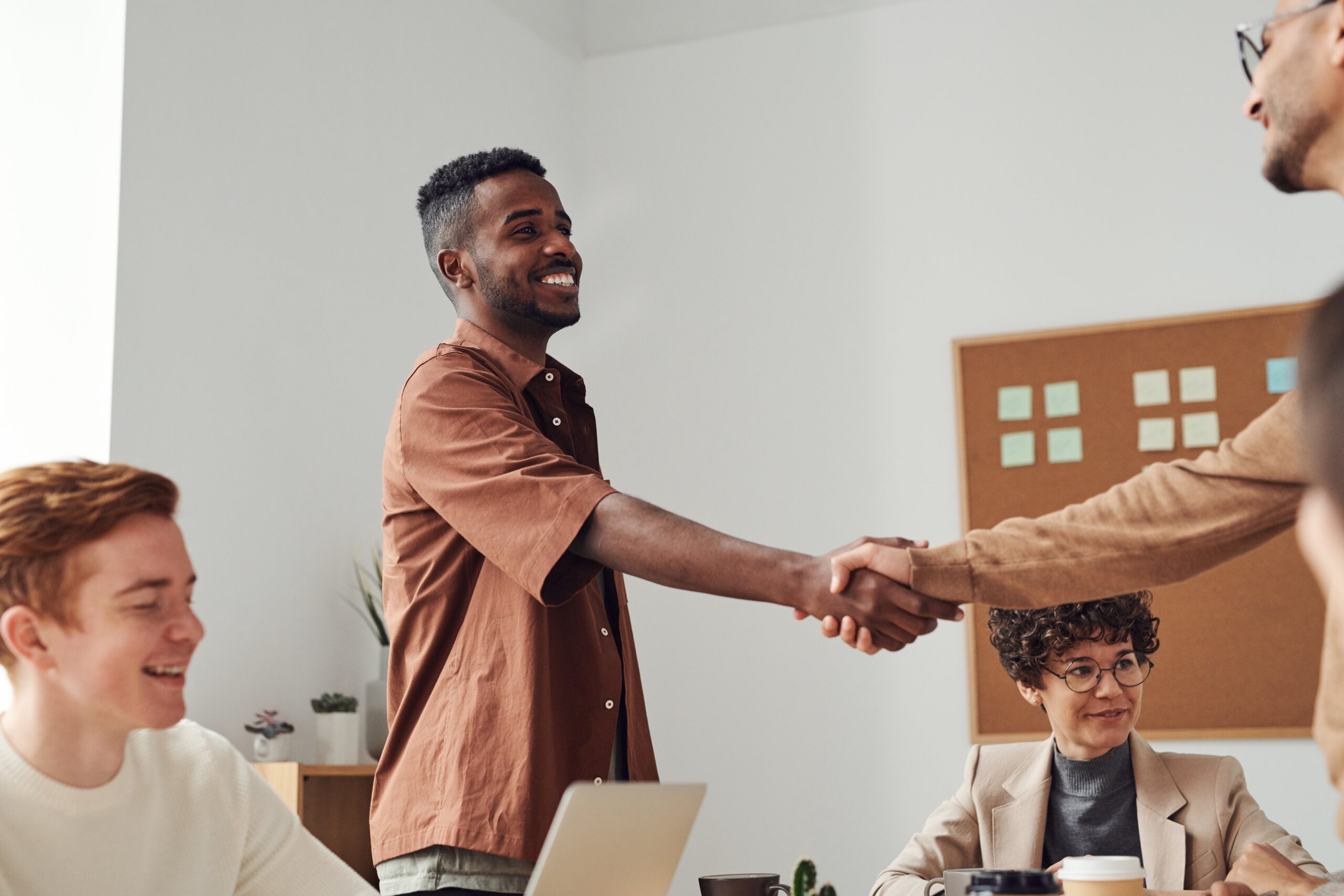 Stock image of people shaking hands - Start your search on Share to Buy today!