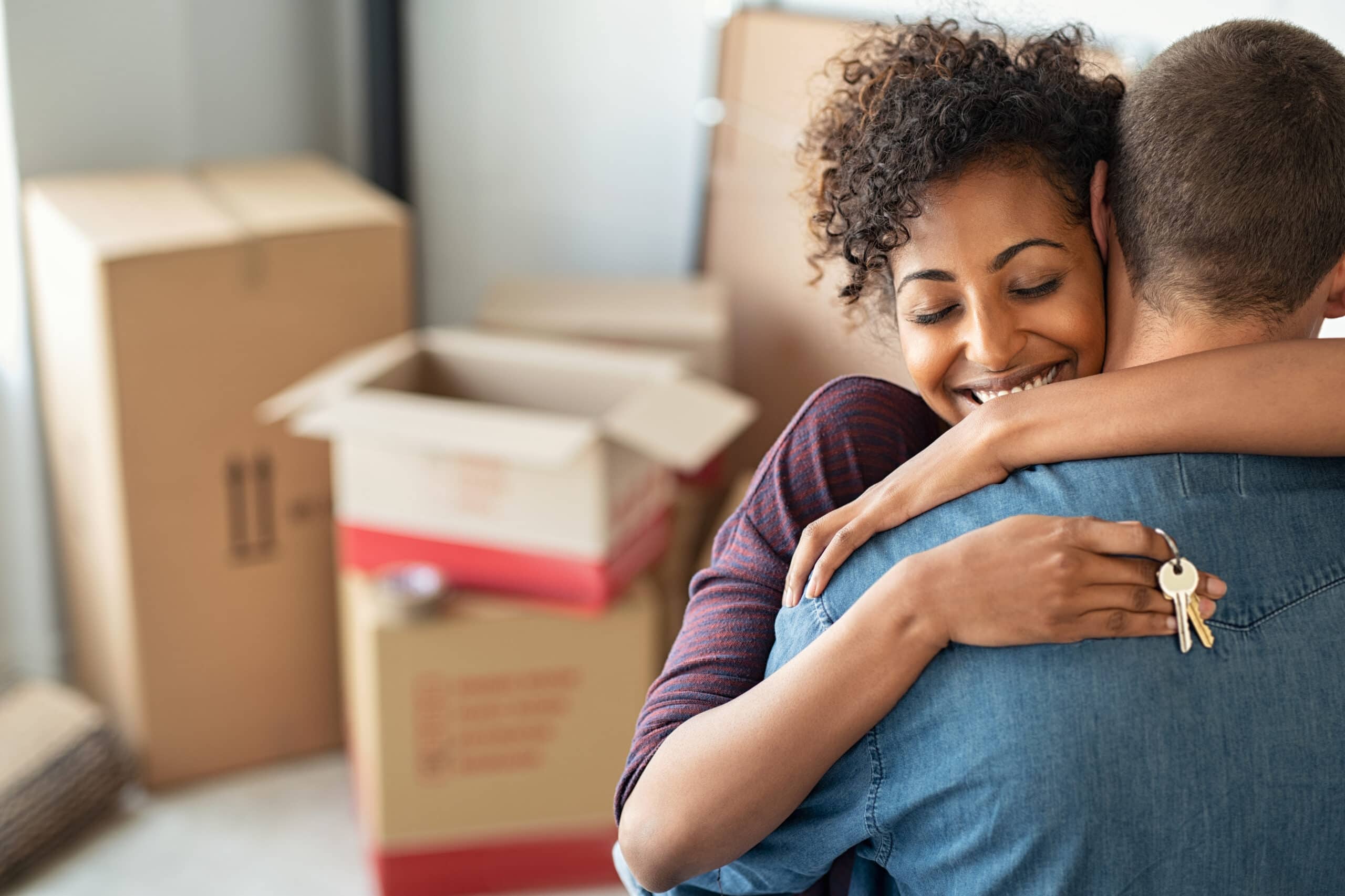 Stock image of people moving into a house - Start your search on Share to Buy today!