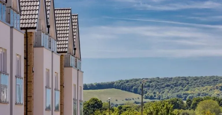 side outdoor view of houses with a view of fields stretching for miles