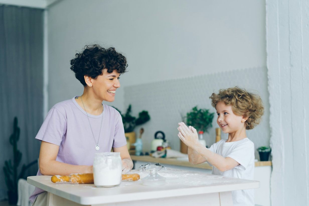 Mother and child having fun in the kitchen