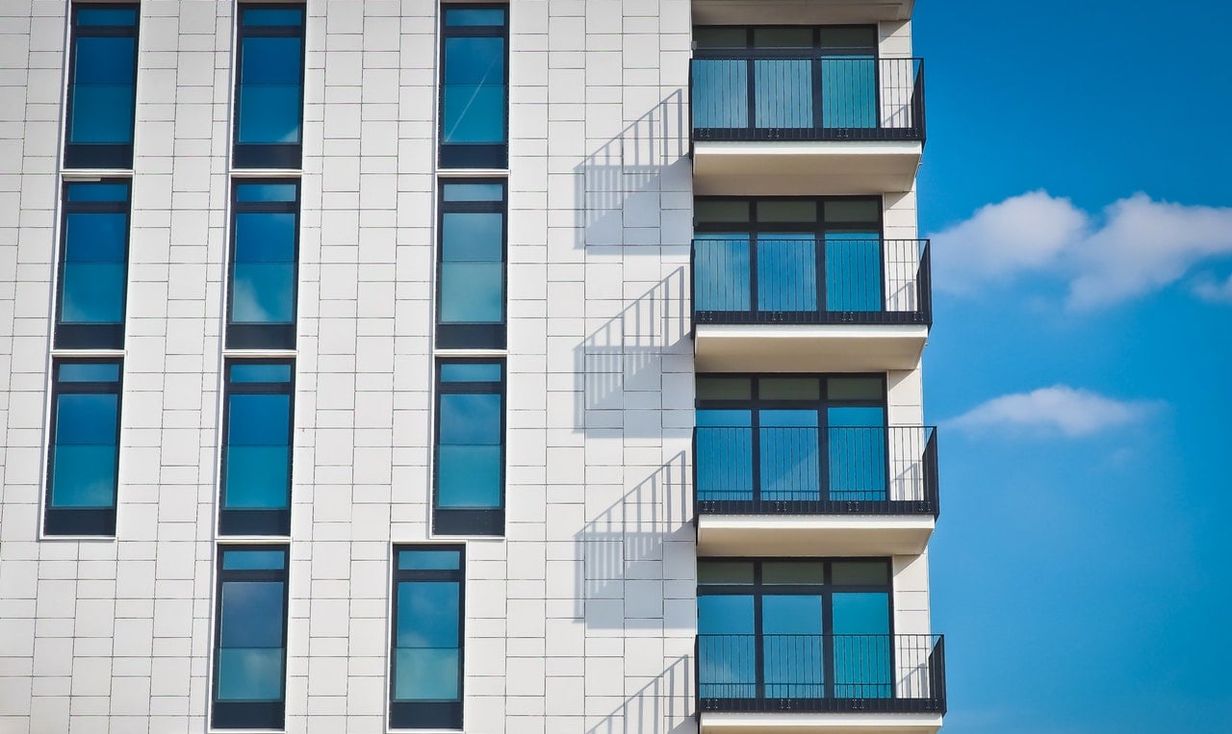 White apartment building against a blue sky