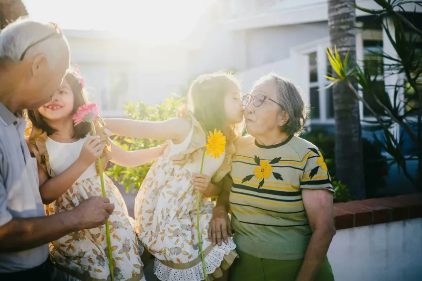 Grandparents and grandkids holding flowers