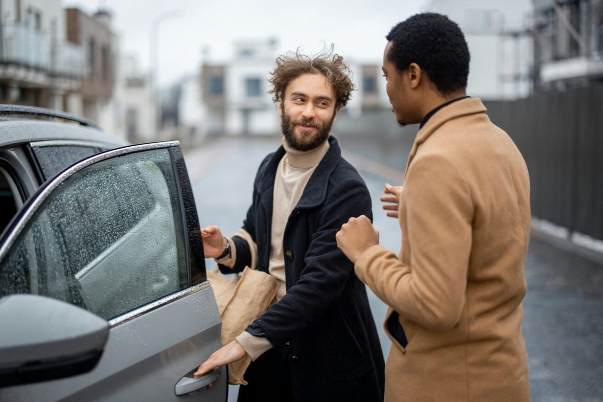 Two men getting into a car