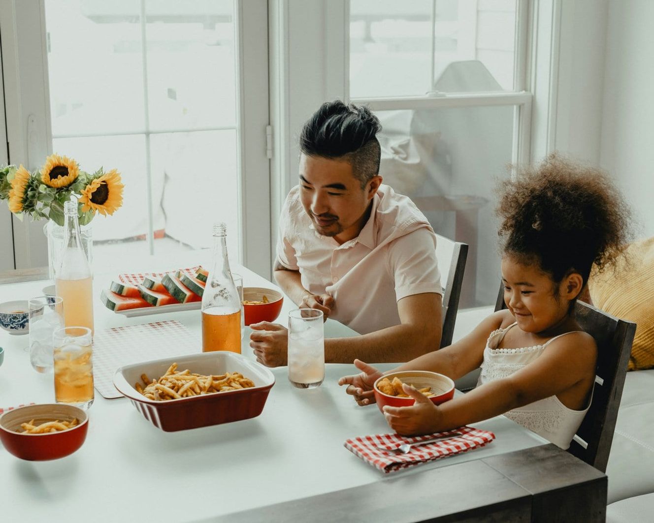 Man eating breakfast with his daughter in a Discount Market Sale property.