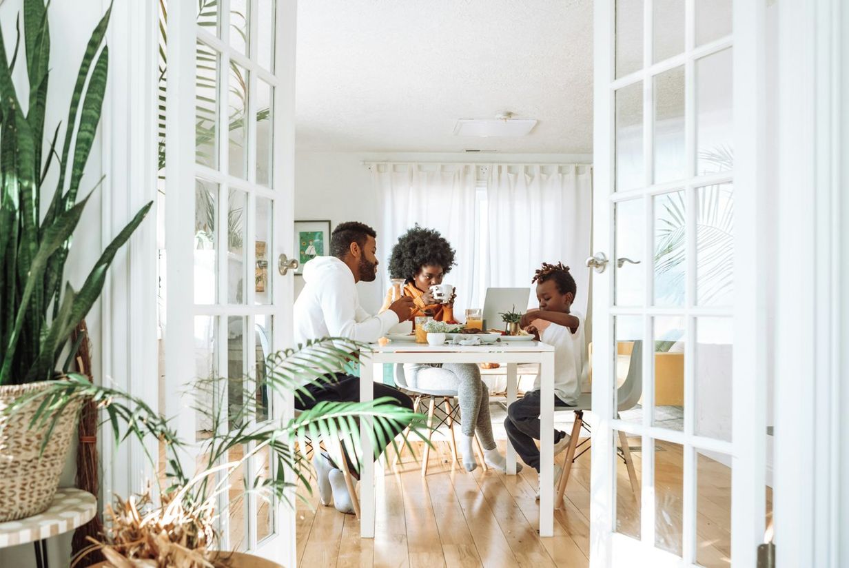 Young family eating round the dinner table