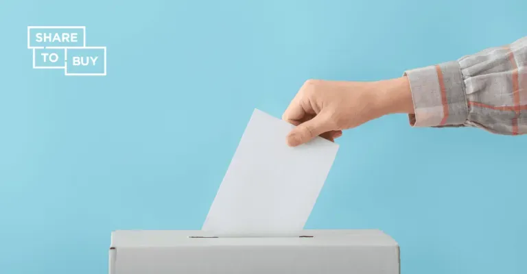 hand placing paper in a ballot box