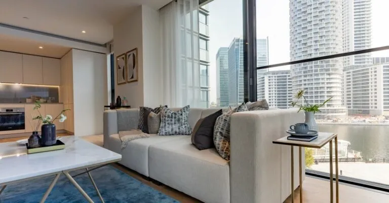 open plan living area with grey sofa and large window