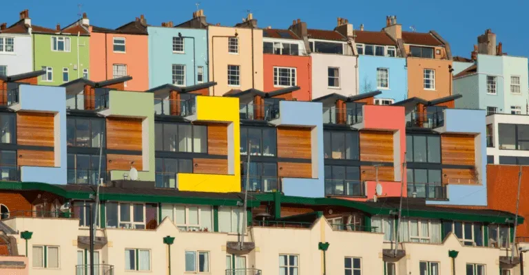 a row of colourful houses reflecting in the water