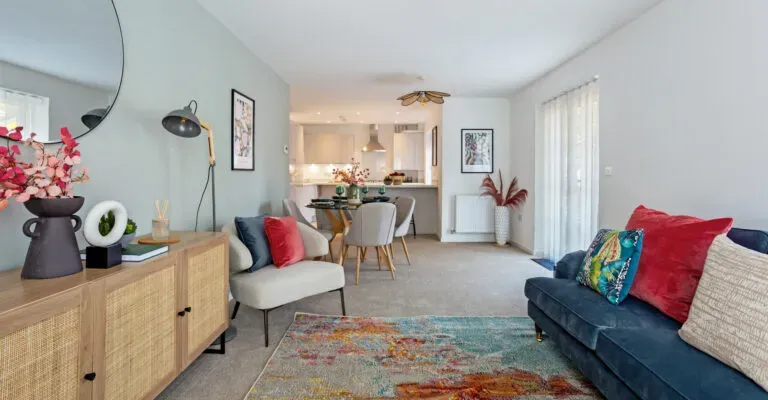 an open plan living room area with sofa dining tables and other interiors