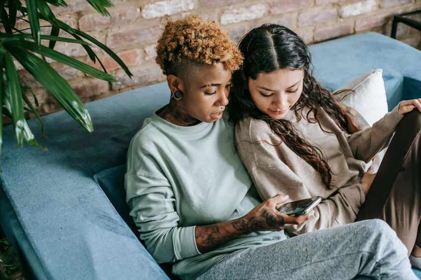 Stock image of couple looking at phone