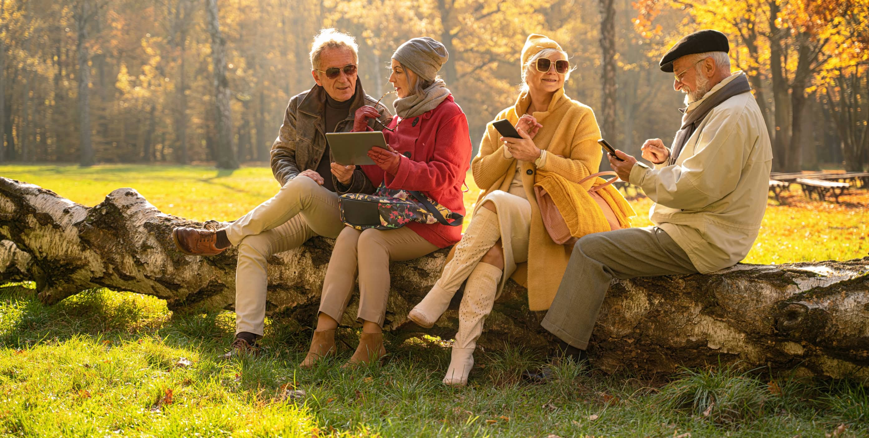 Elderly people on their phones in a park