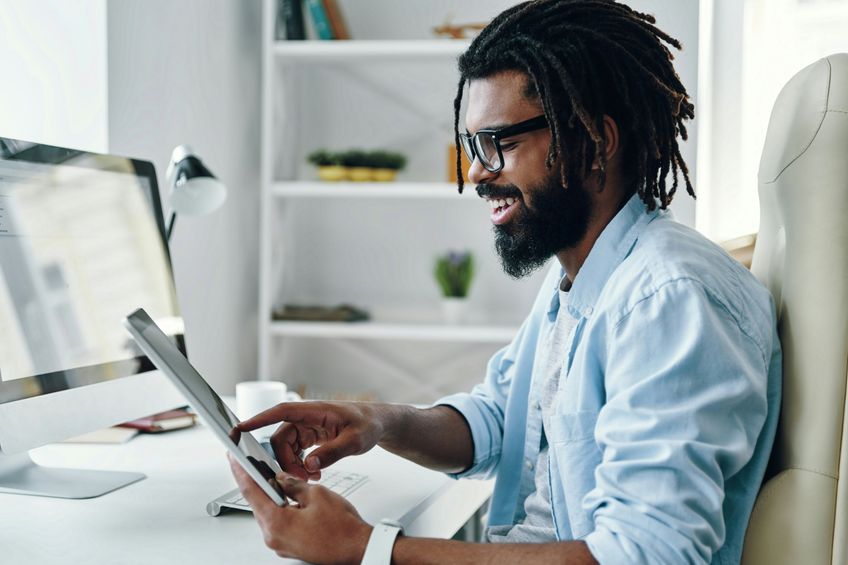 man-smiling-at-desk-r6ru_4Uz6PQ-unsplash.jpg