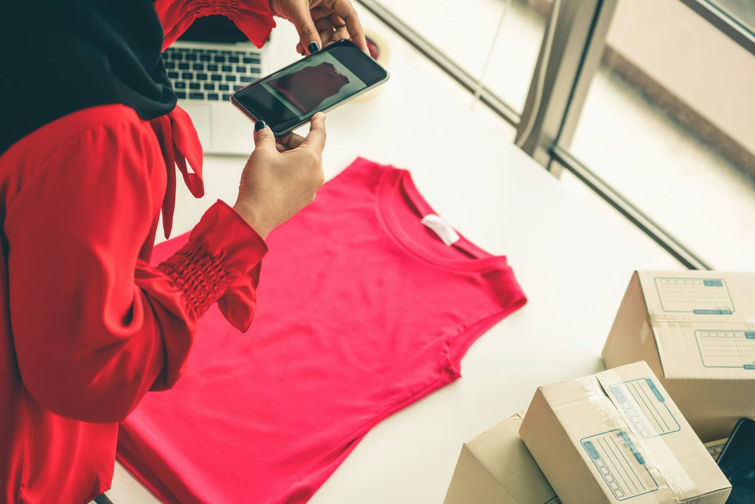 Woman taking photos of clothes to sell online